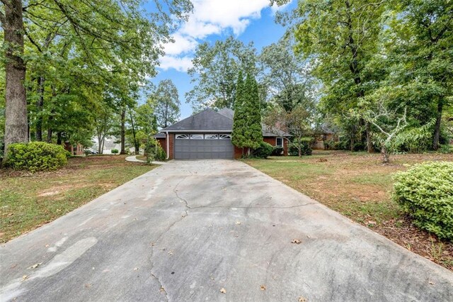 view of front facade with a front yard and a garage