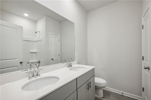 bathroom with tile patterned flooring, vanity, toilet, and walk in shower