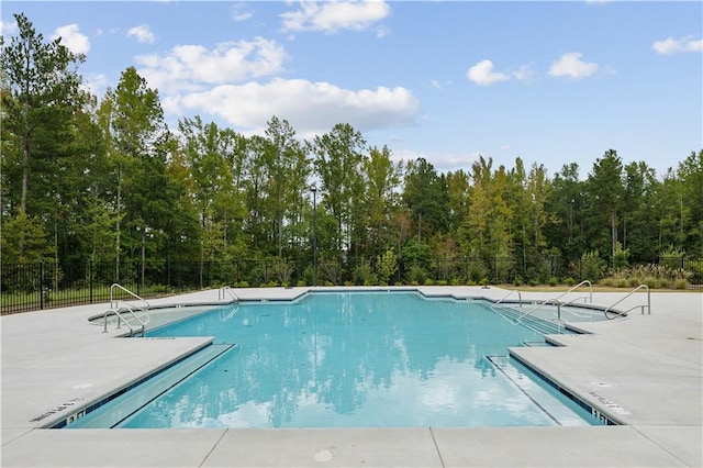 view of swimming pool featuring a patio area