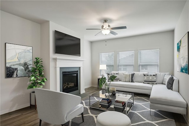 living room featuring ceiling fan and dark hardwood / wood-style flooring