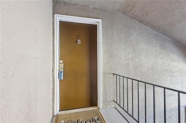 property entrance with stucco siding