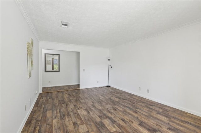 empty room featuring baseboards, a textured ceiling, ornamental molding, and dark wood-style flooring