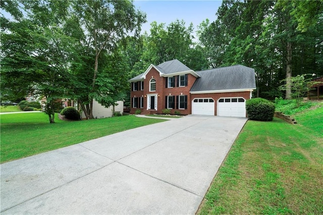 colonial-style house featuring a front yard and a garage