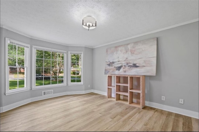 800 Post Road Cir, Stone Mountain, GA 30088 - empty room featuring wood finished floors, crown molding, a textured ceiling, healthy amount of natural light, and baseboards