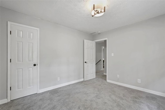800 Post Road Cir, Stone Mountain, GA 30088 - unfurnished bedroom featuring carpet flooring, a textured ceiling, and baseboards
