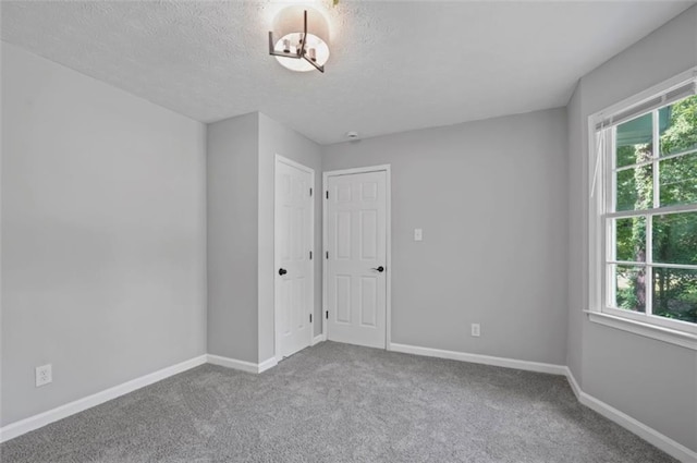 800 Post Road Cir, Stone Mountain, GA 30088 - spare room with plenty of natural light, carpet flooring, baseboards, and a textured ceiling