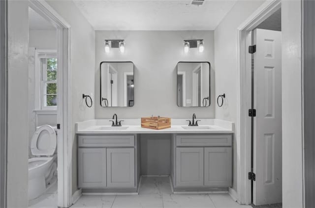 800 Post Road Cir, Stone Mountain, GA 30088 - full bathroom featuring marble finish floors, double vanity, toilet, a textured ceiling, and baseboards