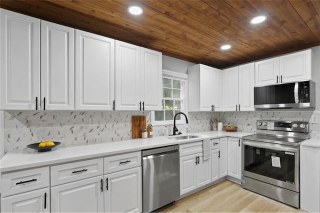 800 Post Road Cir, Stone Mountain, GA 30088 - kitchen featuring appliances with stainless steel finishes, a sink, wood ceiling, recessed lighting, and white cabinets