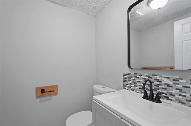 800 Post Road Cir, Stone Mountain, GA 30088 - half bath with a textured ceiling, decorative backsplash, toilet, and vanity