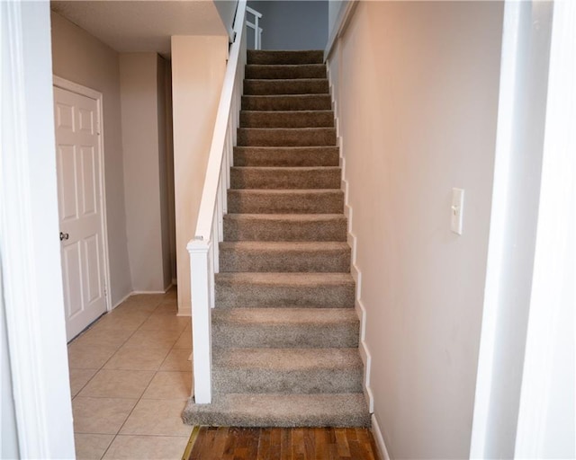 stairway with tile patterned flooring