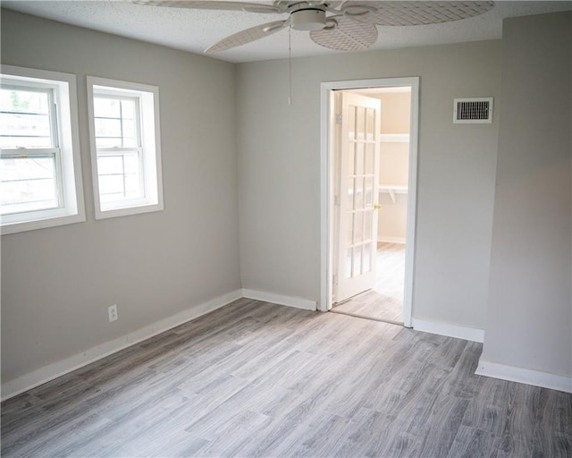 unfurnished room featuring light wood-type flooring and ceiling fan