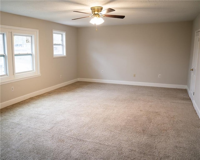 unfurnished room with ceiling fan and carpet floors