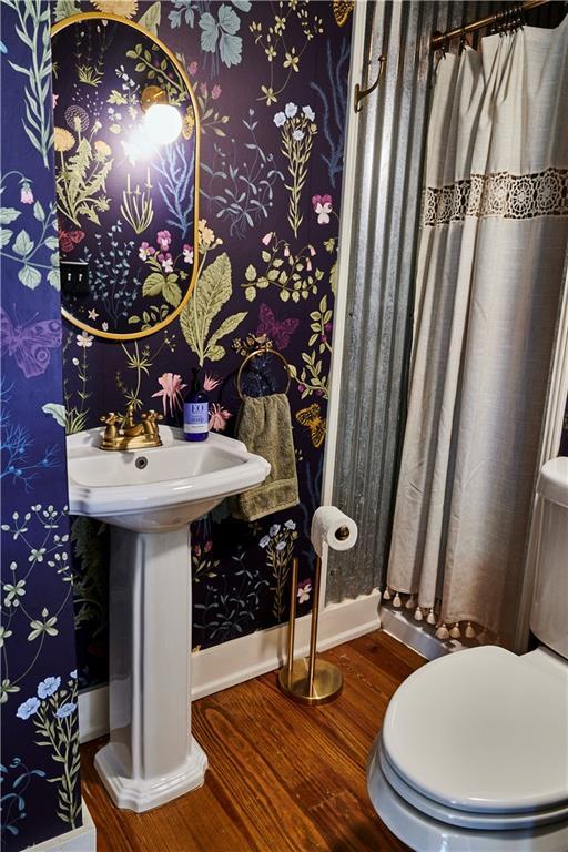 bathroom featuring sink, hardwood / wood-style floors, and toilet