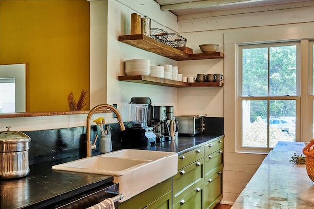 kitchen featuring sink and green cabinetry