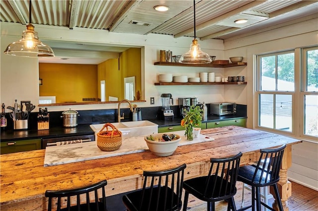 kitchen featuring hanging light fixtures, sink, and hardwood / wood-style floors