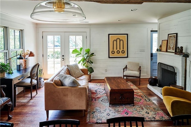 living room featuring french doors, plenty of natural light, and dark hardwood / wood-style flooring