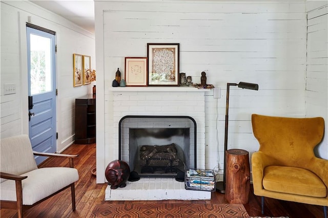 sitting room featuring a fireplace and hardwood / wood-style floors