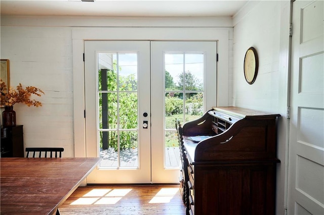 entryway with light hardwood / wood-style flooring and french doors