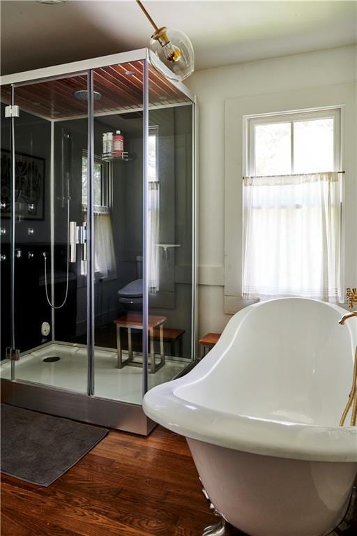 bathroom with wood-type flooring and separate shower and tub