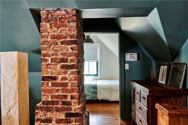 bedroom with hardwood / wood-style floors and vaulted ceiling