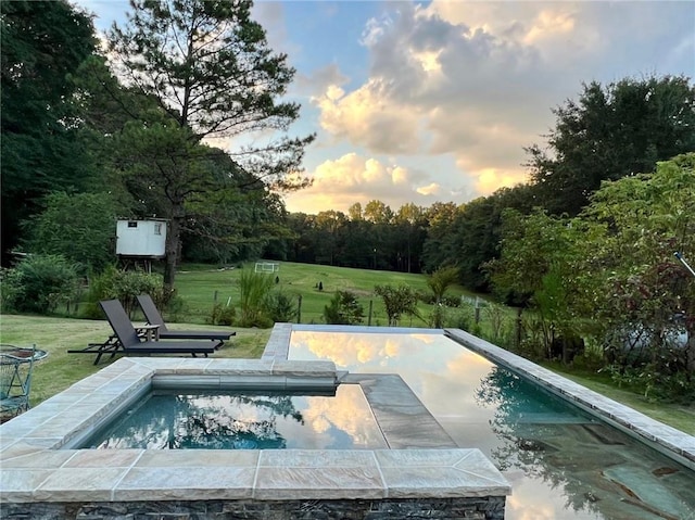 pool at dusk with a yard