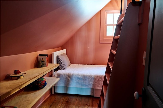 bedroom with vaulted ceiling and dark wood-type flooring