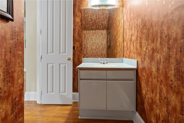 bathroom with vanity and hardwood / wood-style floors