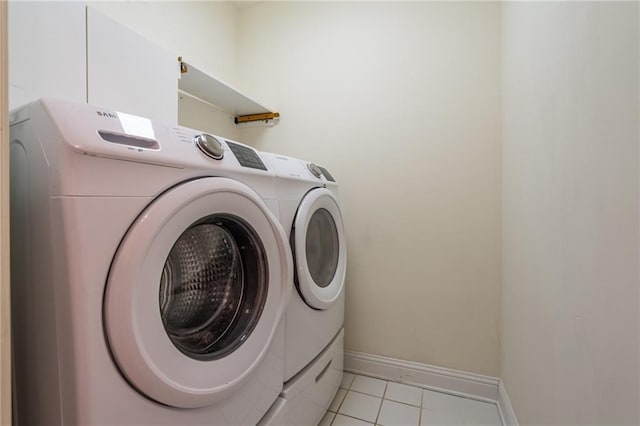 laundry area featuring light tile patterned flooring and washer and clothes dryer