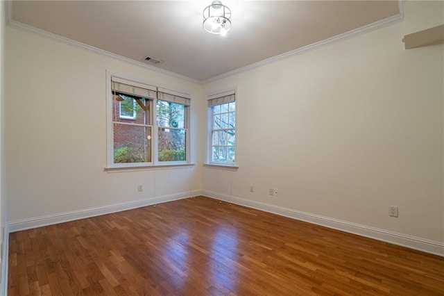 spare room with hardwood / wood-style flooring and ornamental molding