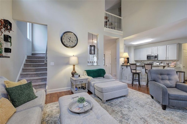 living room featuring hardwood / wood-style floors and a high ceiling