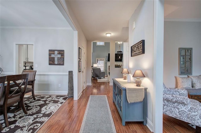 interior space with ornamental molding and light wood-type flooring