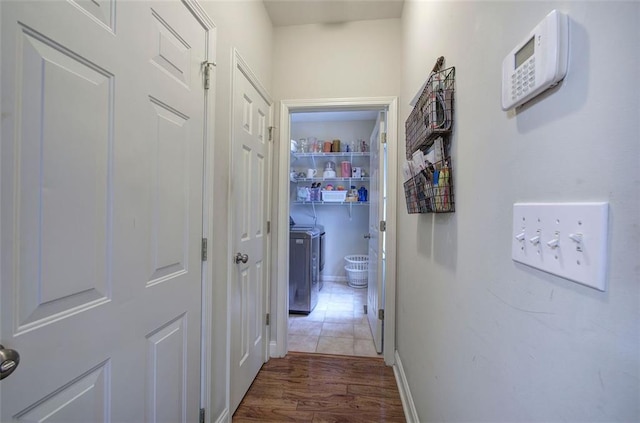 corridor with washer / dryer, dark wood-type flooring, and mail boxes