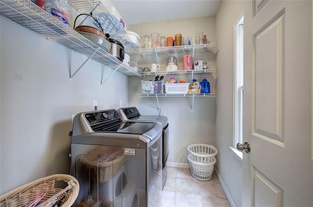 washroom with washing machine and dryer and light tile patterned floors