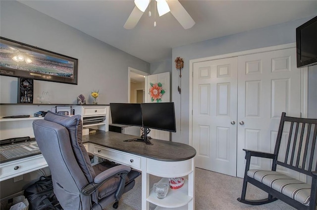 carpeted home office featuring ceiling fan