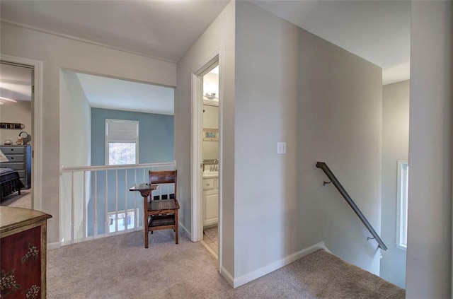 hall with light colored carpet