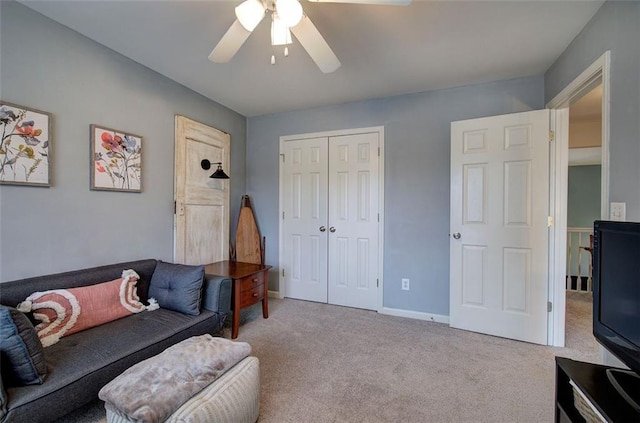 carpeted living room with ceiling fan