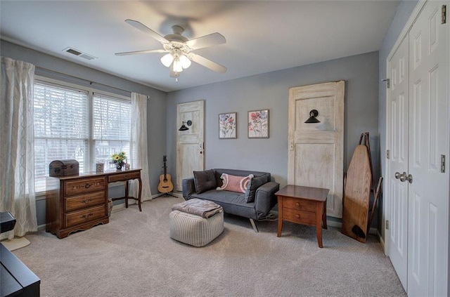 office with ceiling fan and light colored carpet