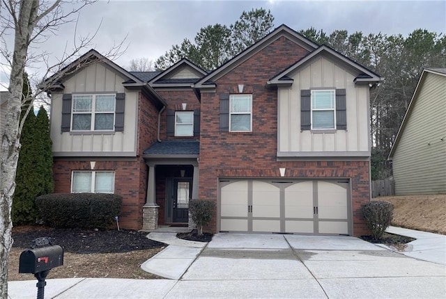 craftsman-style house with a garage, concrete driveway, brick siding, and board and batten siding