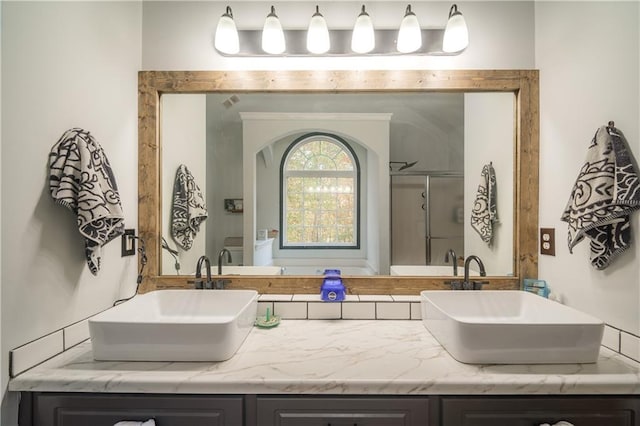 bathroom with an enclosed shower and vanity