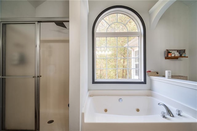 bathroom featuring shower with separate bathtub