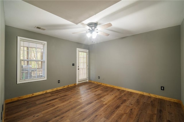 spare room with ceiling fan and dark wood-type flooring