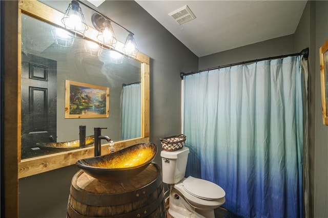 bathroom featuring toilet and vanity