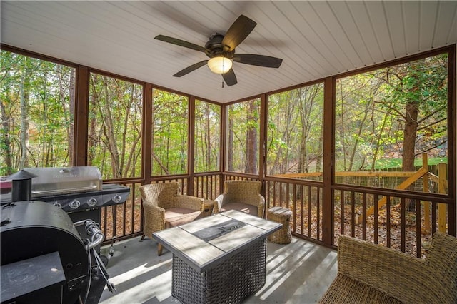 sunroom / solarium featuring ceiling fan