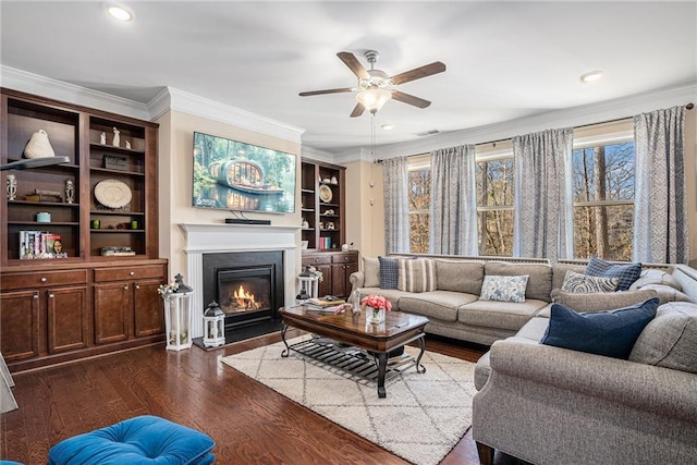 living room with ceiling fan, ornamental molding, and dark hardwood / wood-style floors