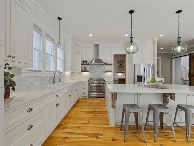 kitchen featuring a sink, wall chimney exhaust hood, stainless steel appliances, backsplash, and ornamental molding