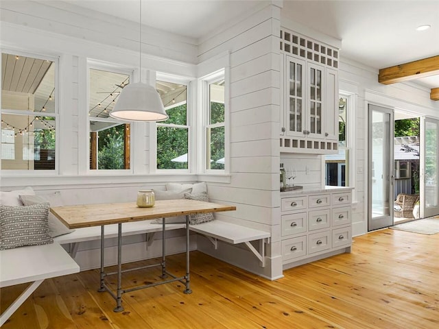 sunroom featuring beamed ceiling
