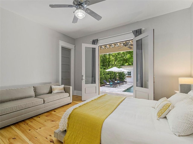bedroom with ceiling fan, wood finished floors, and access to exterior