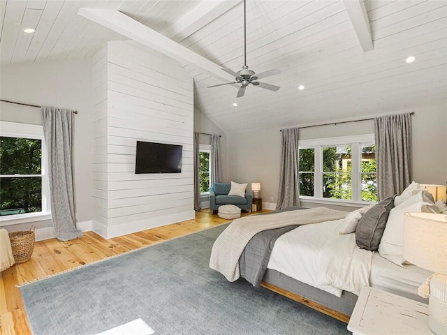 bedroom featuring lofted ceiling with beams and multiple windows