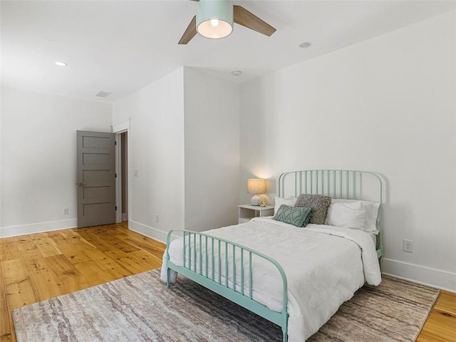 bedroom with a ceiling fan, baseboards, recessed lighting, and wood finished floors