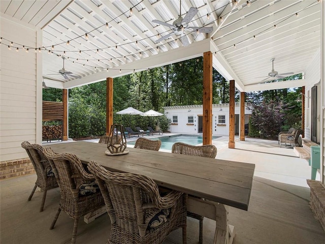view of patio featuring a ceiling fan, outdoor dining space, and an outdoor pool